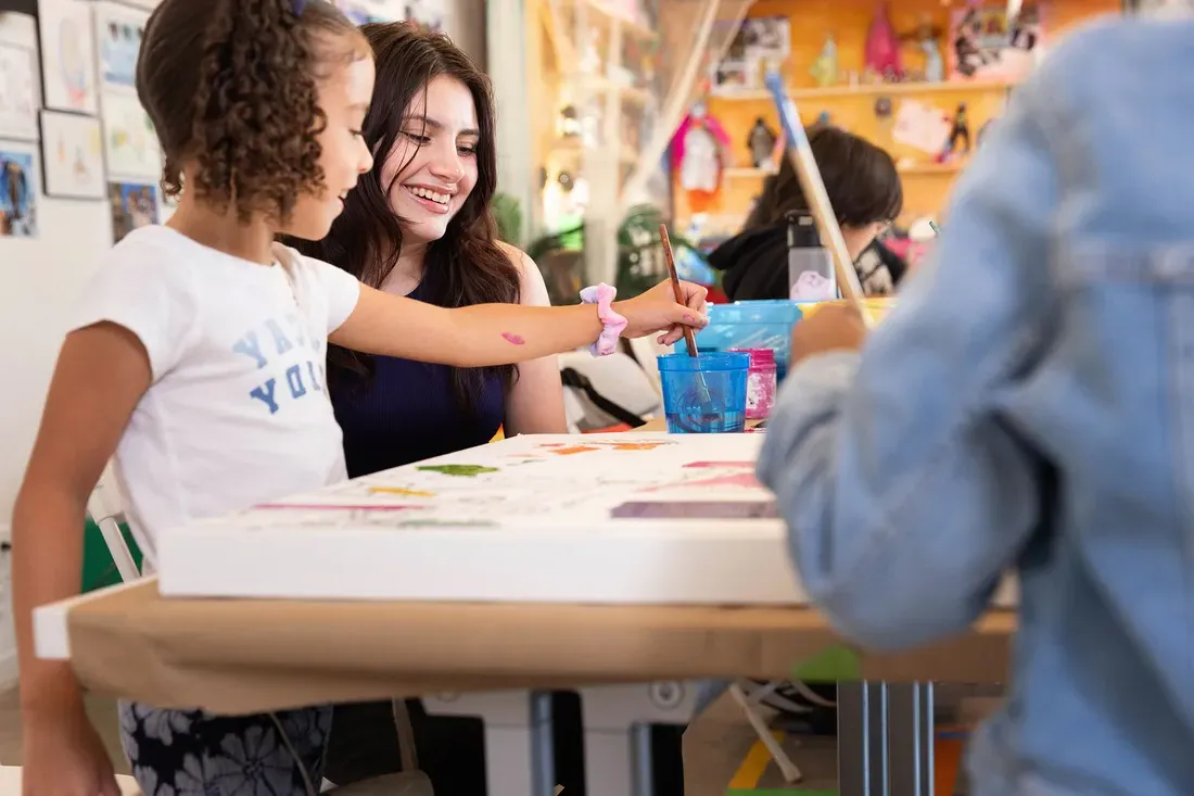 Student teacher teaching children in a classroom.